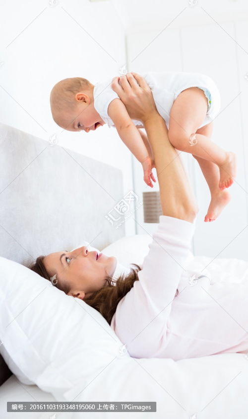 躺在床上抱起婴儿的母亲