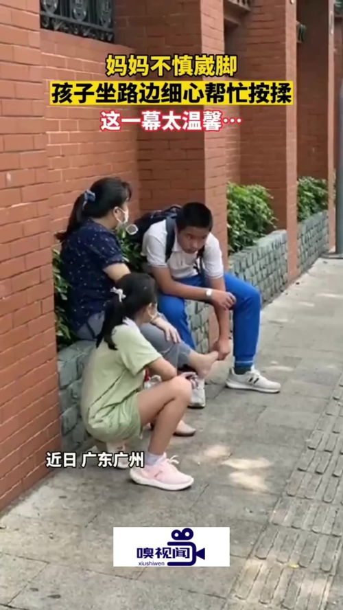 广东广州 学校门口妈妈不慎崴脚,孩子坐路边帮其细心按揉 