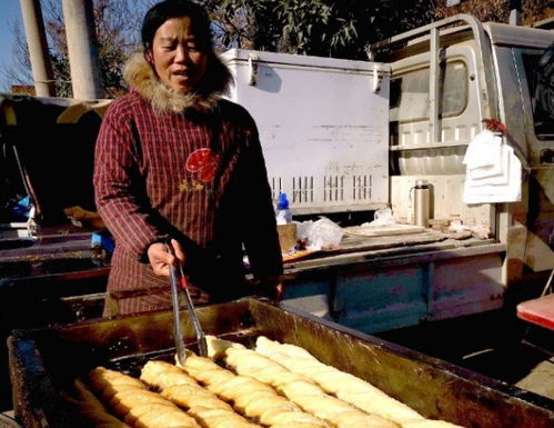 路边摊现 超级大油条 ,买一根就够全家吃 想买,后边排队去